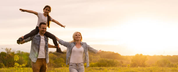 istock family is walking in a field 1319836115