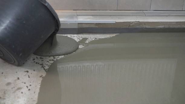 istock Leveled dry cement-sand mixture on the floor surface in a building under construction. Concrete work on filling floors with hand tools. The process of filling the floor with mortar. 1319836162