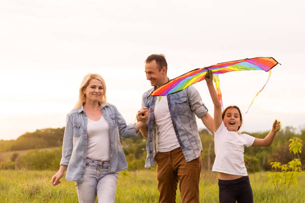istock family is walking in a field 1319836173