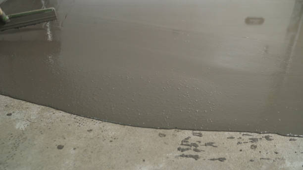 istock Pour the liquid floor onto the concrete surface. Leveling the floor with a self-leveling mortar. Leveling the floor with a self-leveling mortar. 1319836220