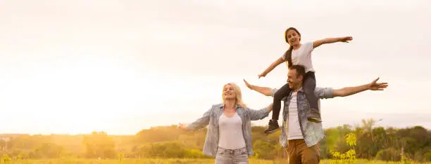 Photo of Young happy family in a field