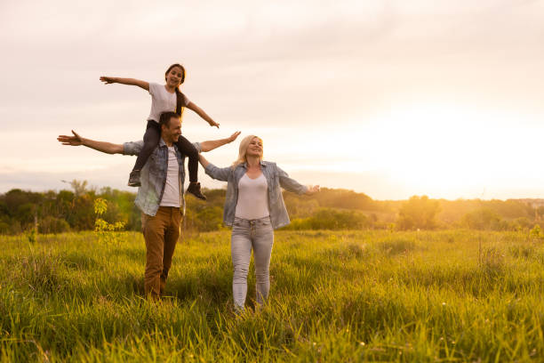 istock family is walking in a field 1319836544