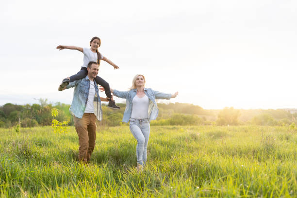 istock Young happy family in a field 1319836828
