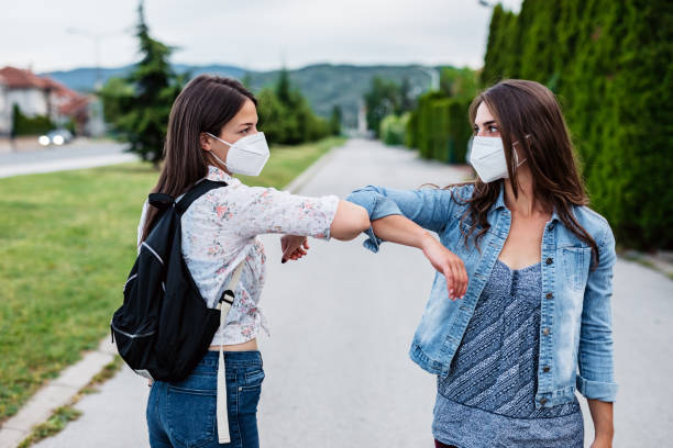 istock Two friends greeting during pandemic 1319837913