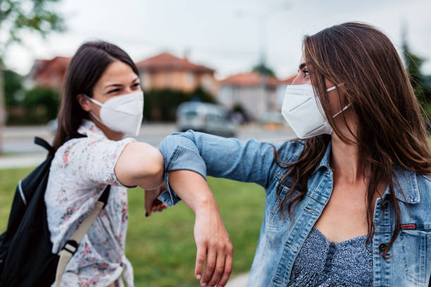 istock Two friends greeting during pandemic 1319837948