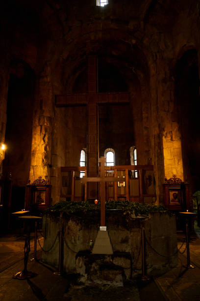 istock Dark temple with small windows and burning candles 1319838887