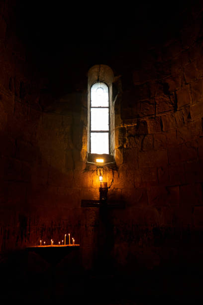 istock Dark temple with small windows and burning candles 1319839032