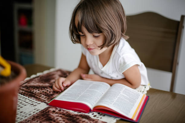 istock Child with reading bible holy book on the table. 1319839043