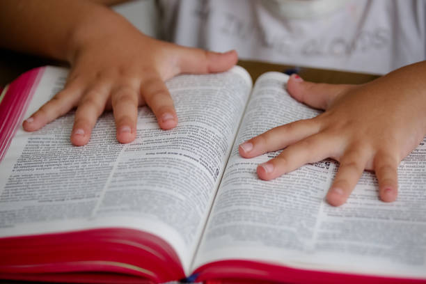 istock Child with reading bible holy book on the table. 1319839132