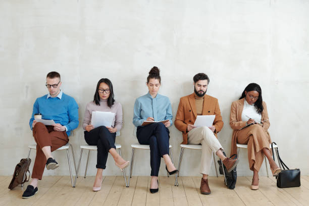 istock Candidates for jobs sitting with papers 1319840350
