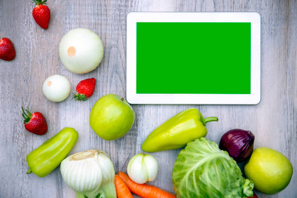 istock Green tablet screen and fresh vegetable and fruit 1319841369
