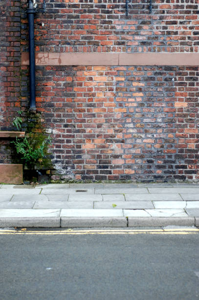 istock Urban background UK - Red brick wall with sidewalk 131984177