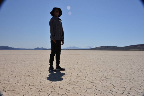 istock Tall Man Standing In Vast Desert 1319842683