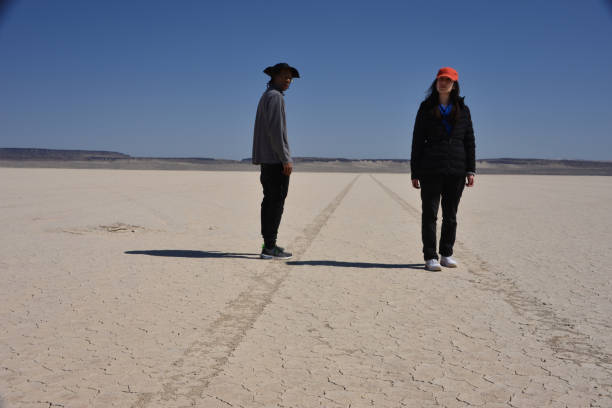 istock Man And Woman In The Desert 1319842710