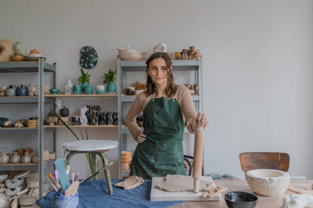 istock Female ceramist working in her studio. Looking at camera 1319845671