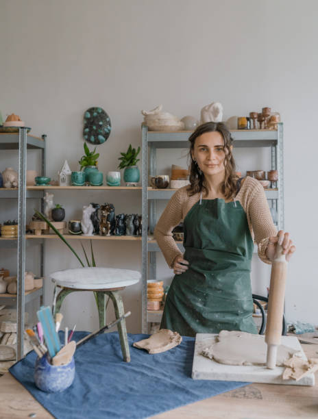 istock Female ceramist working in her studio. Looking at camera 1319845676
