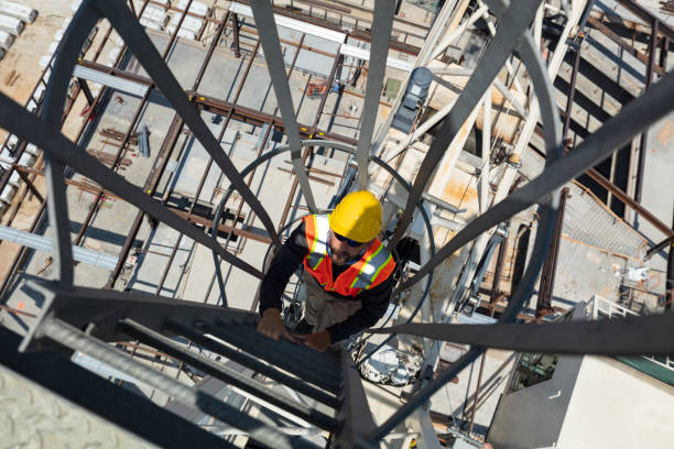 Construction Worker Ascending A Ladder to the Top of A Crane