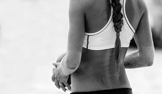 A Female Beach Volleyball Player is Getting Ready to Serve the Ball