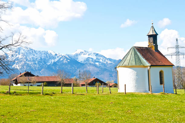istock Small chapel in front of a snow covered mountain in spring 1319847037