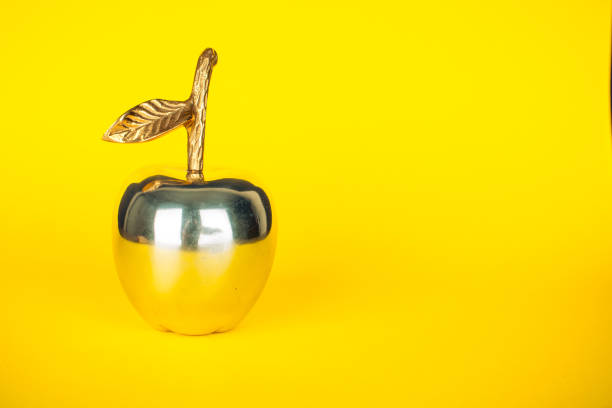 istock Metal Apple on Yellow 1319847137