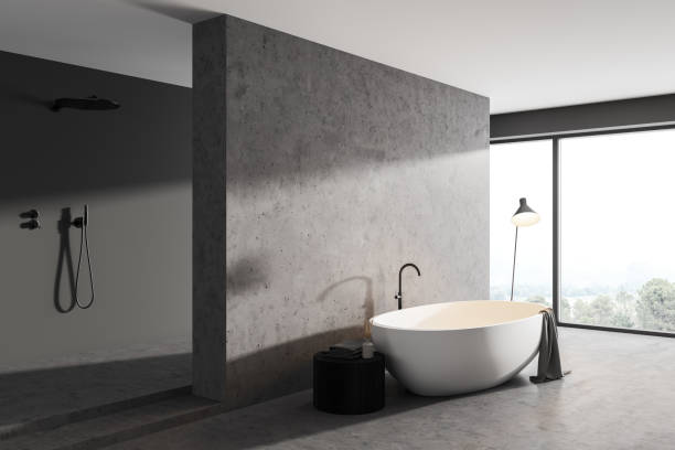 istock Bathroom interior with bathtub, lamp and shower with windows on countryside 1319850961