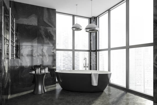 istock Bathroom interior with black bathtub and panoramic window on concrete floor 1319851254