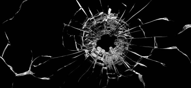 istock Bullet hole in the glass. Isolated on a black background. 1319852437
