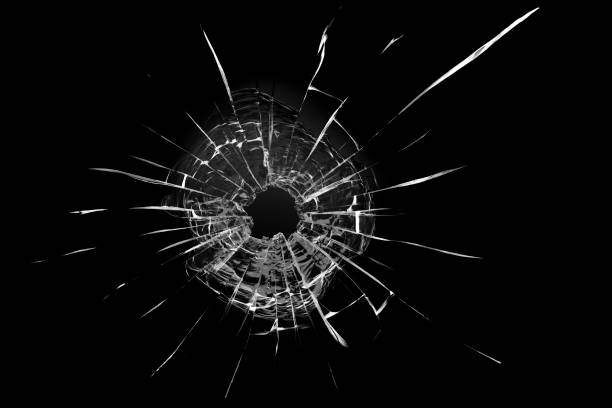 istock Bullet hole in the glass. Isolated on a black background. 1319852438
