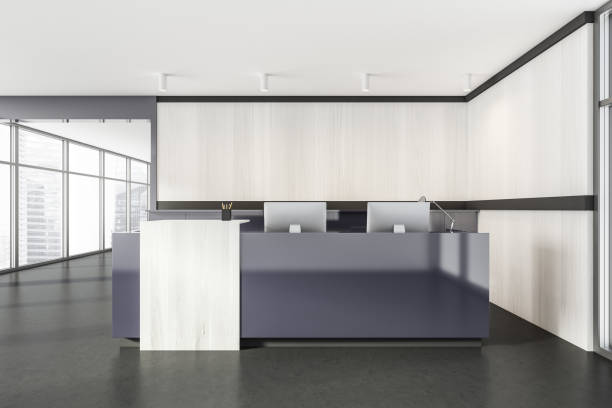istock Grey and white wooden reception room interior with computers on marble floor 1319852757