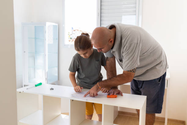 istock Father and son assembling furniture together. DIY 1319853678