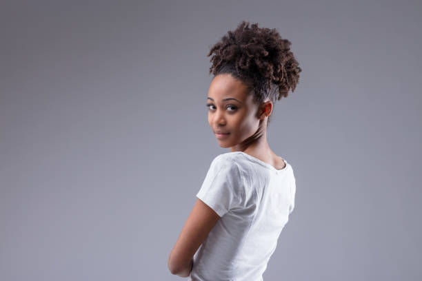 istock Attractive slim young Black woman looking back over shoulder 1319853785