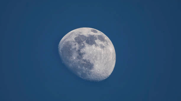 istock Moon on a background of blue sky. 1319853932