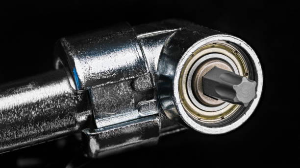istock Replaceable metal hexalobular tip in cordless screwdriver right angle head on a black background 1319853942