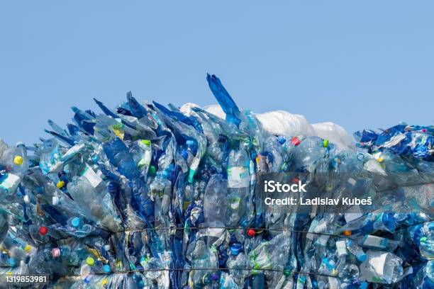 Used Plastic Trash Pressed Beverage Packagings On A Blue Sky Background Stock Photo - Download Image Now