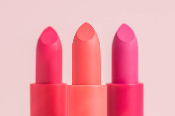 istock Three lipsticks close-up on a pink background. 1319855866
