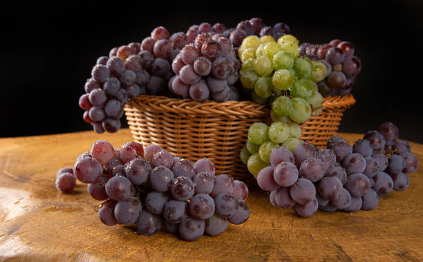 istock grapes, basket with dewy Brazilian grapes on rustic wood, selective focus. 1319857250