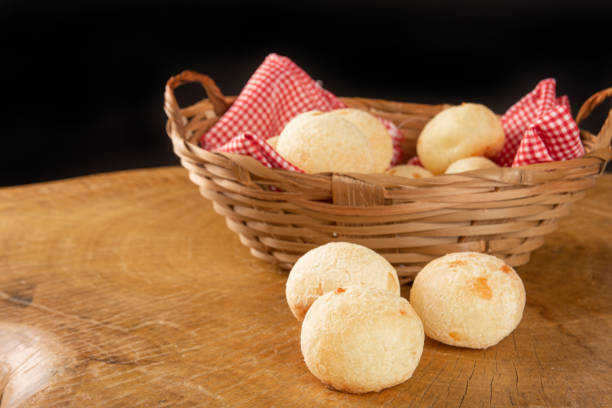 istock Brazilian cheese bread, basket with checkered cloth with cheese breads on rustic wood, selective focus. 1319857403
