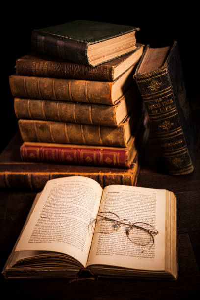 istock Stack of Antique Hardcover Books with Eyeglasses 1319858458