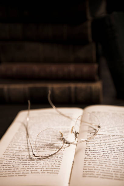 istock Stack of Antique Hardcover Books with Eyeglasses 1319858509