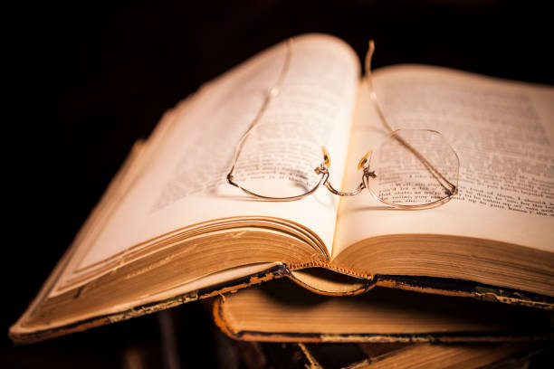 istock Stack of Antique Hardcover Books with Eyeglasses 1319858524