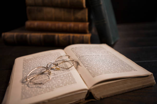 istock Stack of Antique Hardcover Books with Eyeglasses 1319858627
