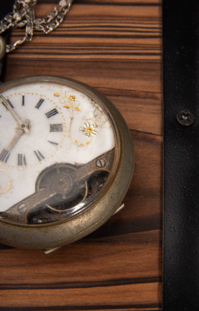 istock Old clock, beautiful details of an old clock on rustic wooden surface, selective focus. 1319858751