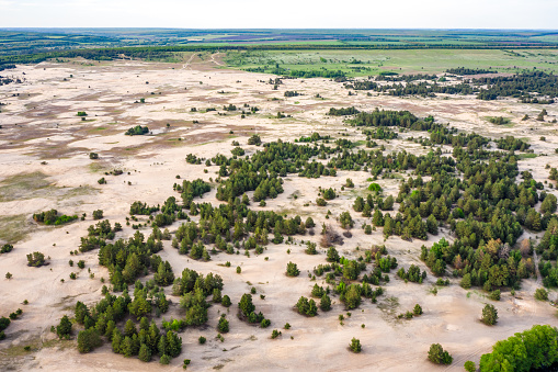 Aerial view to natural Ukrainian desert near Kitsevka, Kharkiv region. Sand desert formed in pine forest by soil erosion