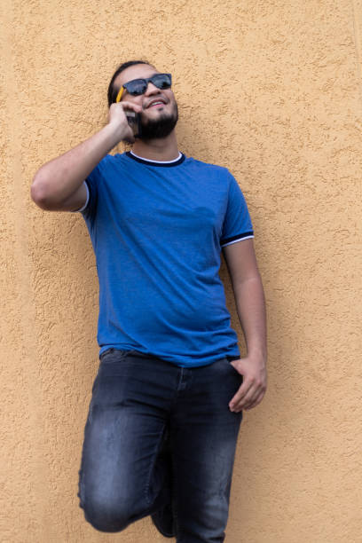 istock Young latino man making a phone call on his smart phone. Technology concept 1319862312