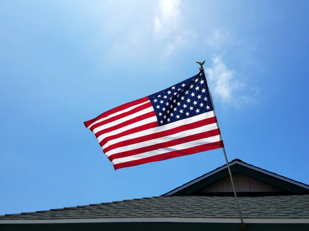 istock American Flag Flying From House Roof 1319863136