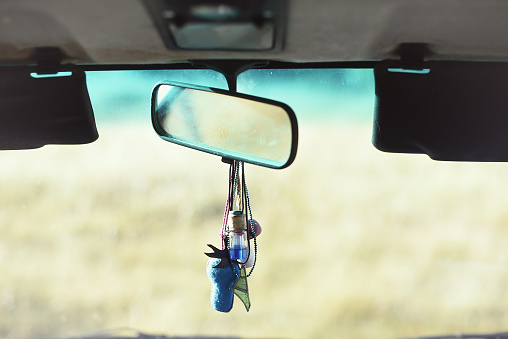 Detail of rear-view mirror in the interior of a rural van