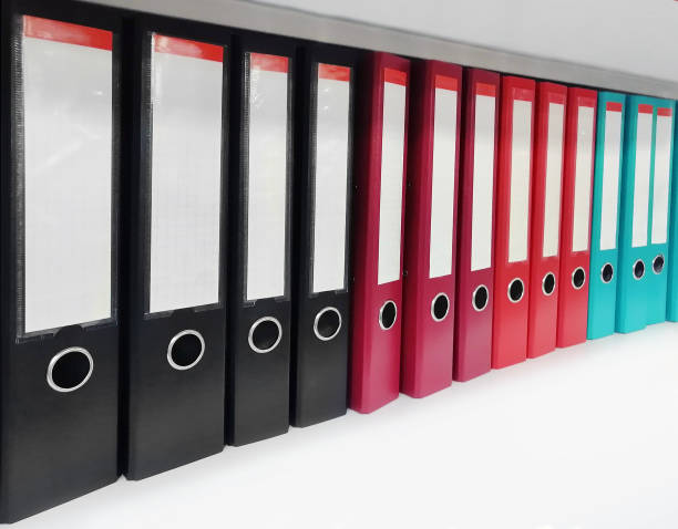 istock Colorful document folders on a white bookshelf 1319863917