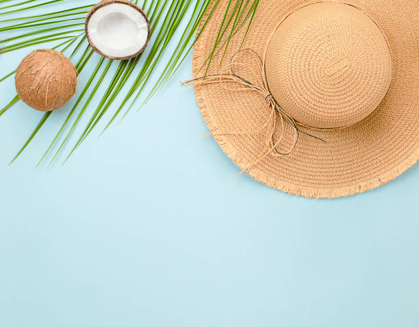 istock sun hat, palm leaves and coconut 1319864104