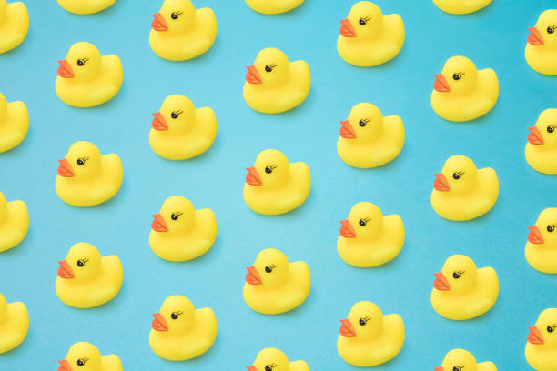 istock Arranged yellow rubber duck on a blue background. 1319865090