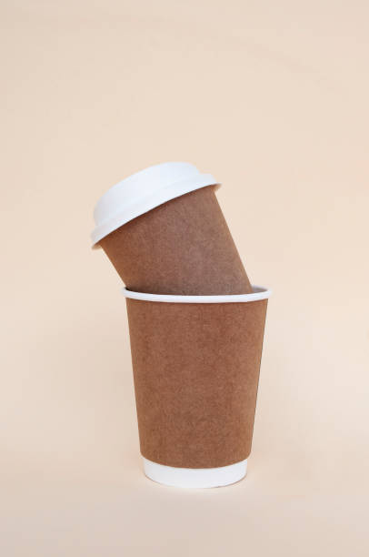 istock Biodegradable paper brown coffee cups with biodegradable white lids. 1319866279